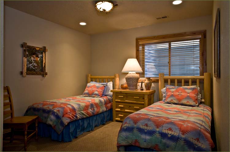 Fourth bedroom features twin beds and private bathroom.