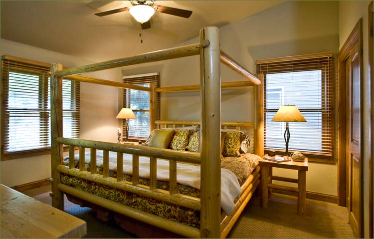 Large master bedroom upstairs features a king sized bed and mountain views.